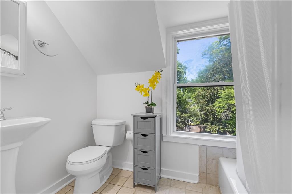 449 Nelson Ferry Road Decatur, GA 30030 - Photo 14 of 29 a white toilet sitting next to a bathroom sink