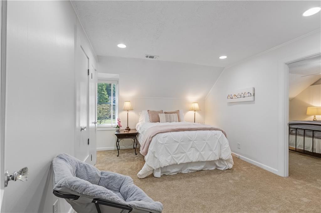 449 Nelson Ferry Road Decatur, GA 30030 - Photo 15 of 29 a spacious bedroom with a bed and a window
