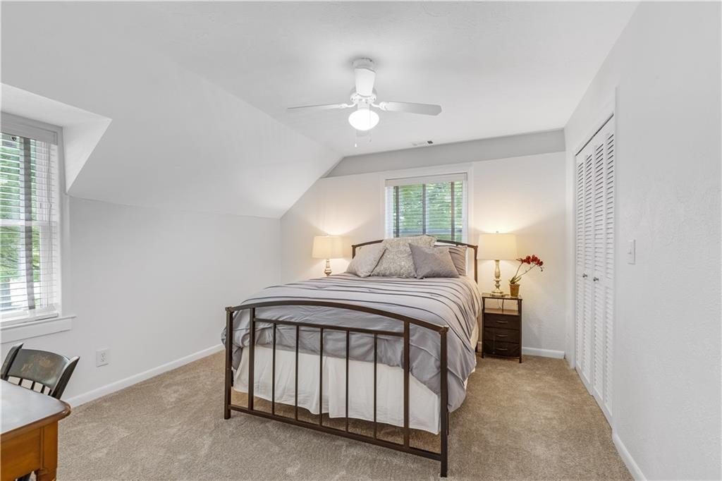 449 Nelson Ferry Road Decatur, GA 30030 - Photo 16 of 29 a bedroom with a bed and a chandelier