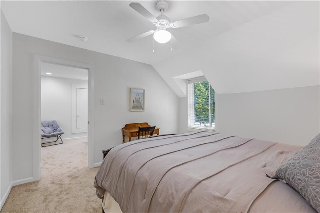 449 Nelson Ferry Road Decatur, GA 30030 - Photo 17 of 29 a bedroom with a bed and a chandelier