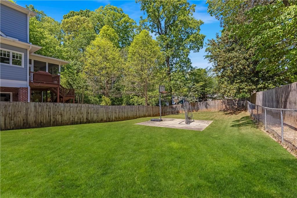 449 Nelson Ferry Road Decatur, GA 30030 - Photo 25 of 29 a view of a backyard with table and chairs and wooden fence