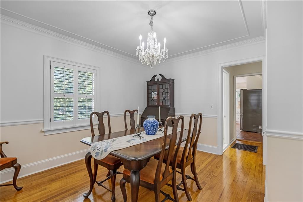449 Nelson Ferry Road Decatur, GA 30030 - Photo 7 of 29 a view of a dining room with furniture a chandelier and wooden floor