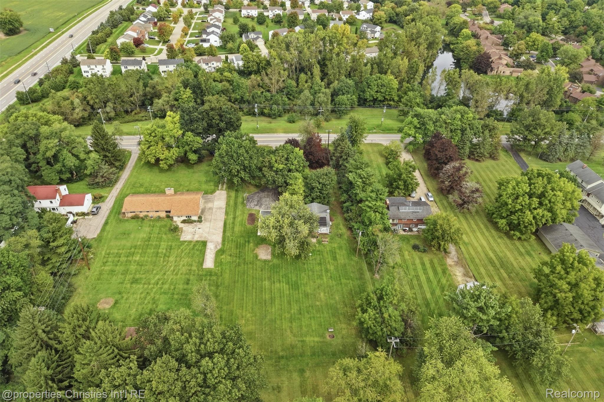4030 Textile Road Ypsilanti, MI 48197 - Photo 50 of 58 Expansive lot featuring mature trees, a manicured lawn, and a paved driveway