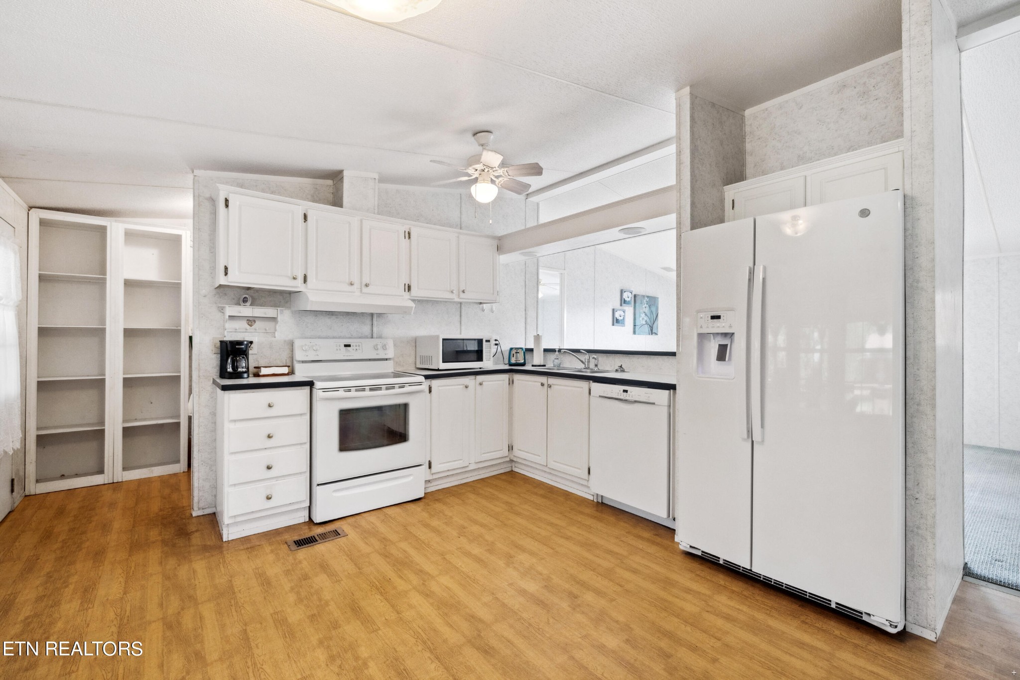 1022 Ridgeview Road Maryville, TN 37801 - Photo 5 of 24 a kitchen with white cabinets and white appliances