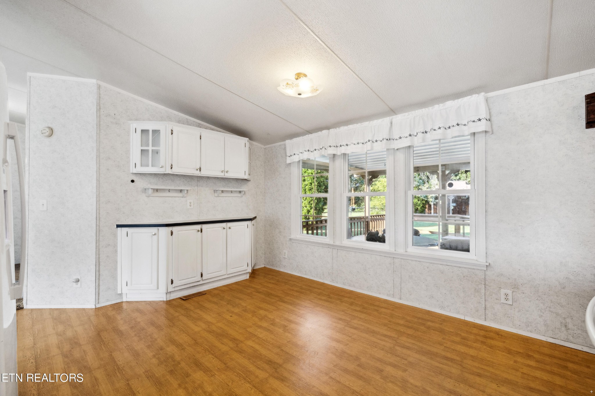 1022 Ridgeview Road Maryville, TN 37801 - Photo 6 of 24 a view of a kitchen with wooden floor and electronic appliances