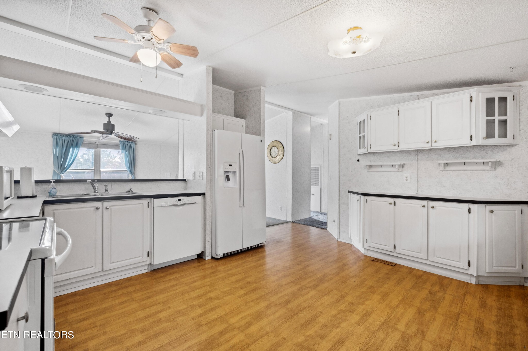 1022 Ridgeview Road Maryville, TN 37801 - Photo 8 of 24 a hallway with white cabinets and wooden floor