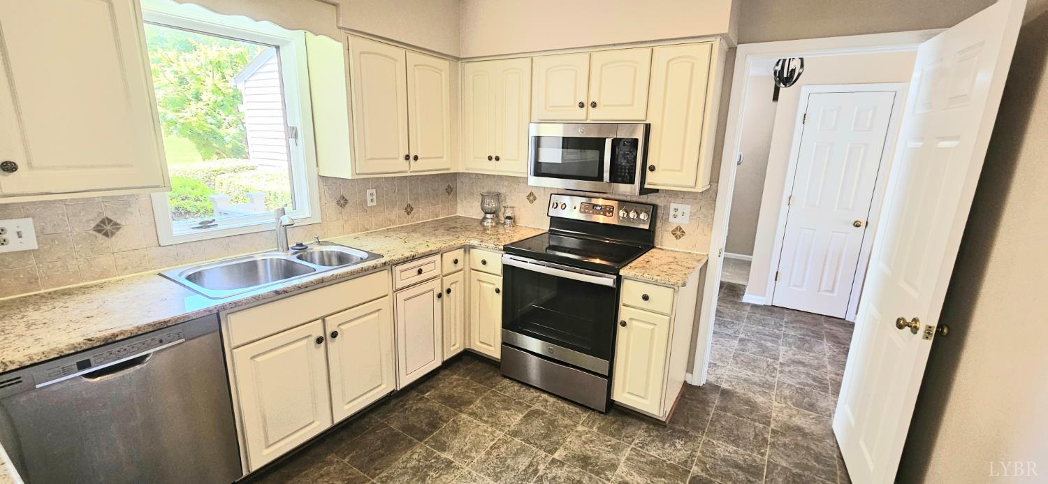 204 Shaker Lane Forest, VA 24551 - Photo 28 of 41 a kitchen with granite countertop white cabinets and white appliances