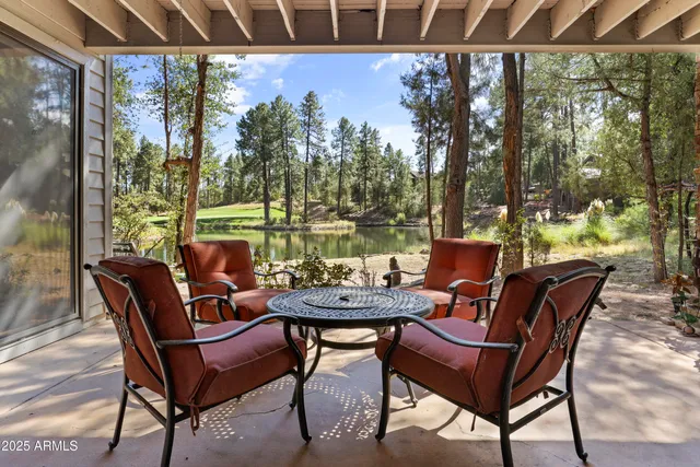 a view of a chairs and table in patio with a yard