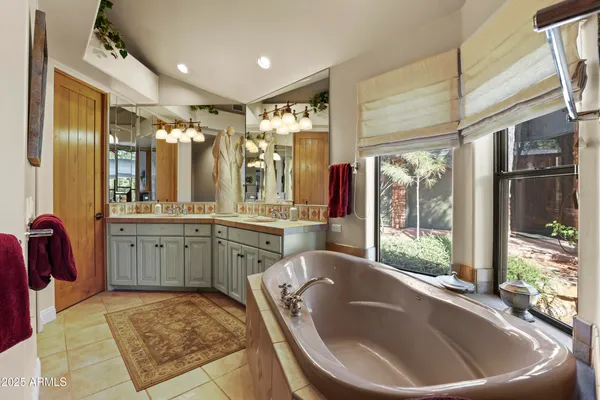 a large bathroom with a large tub and sink