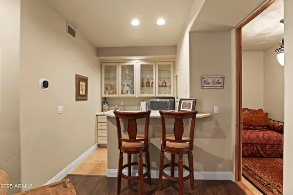 a dining room with furniture and wooden floor