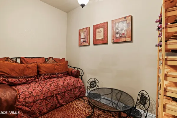 a bed sitting in a bedroom next to a window and painting on the wall