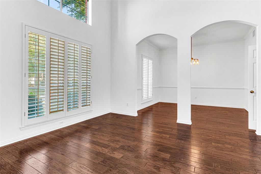 4332 Risinghill Drive Plano, TX 75024 - Photo 12 of 29 The formal living room gleams with fresh paint (2025) and a double row of windows, including plantation shutters!