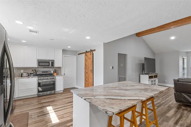 a large kitchen with a table and chairs in it