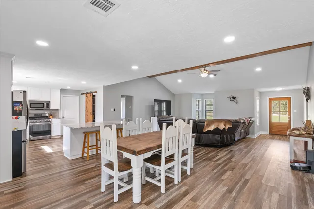 a view of a dining room with furniture wooden floor and chandelier