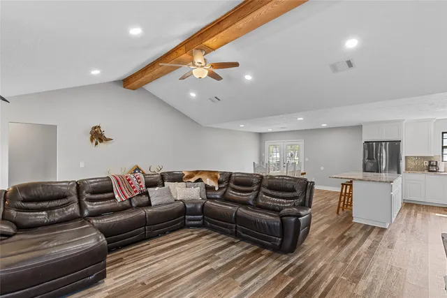 a living room with furniture and wooden floor