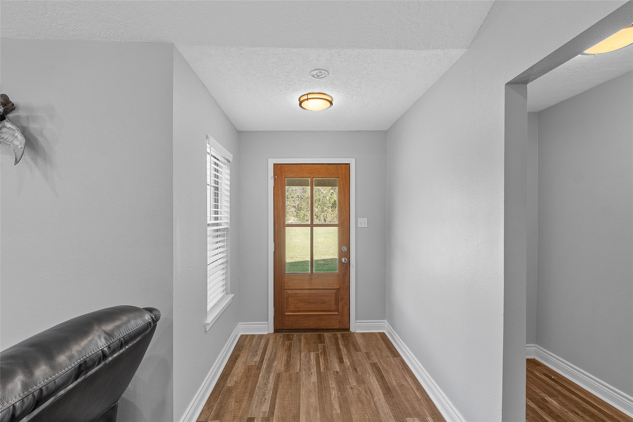 11050 Antioch Road Midway, TX 75852 - Photo 19 of 34 a view of a hallway with wooden floor and a workspace