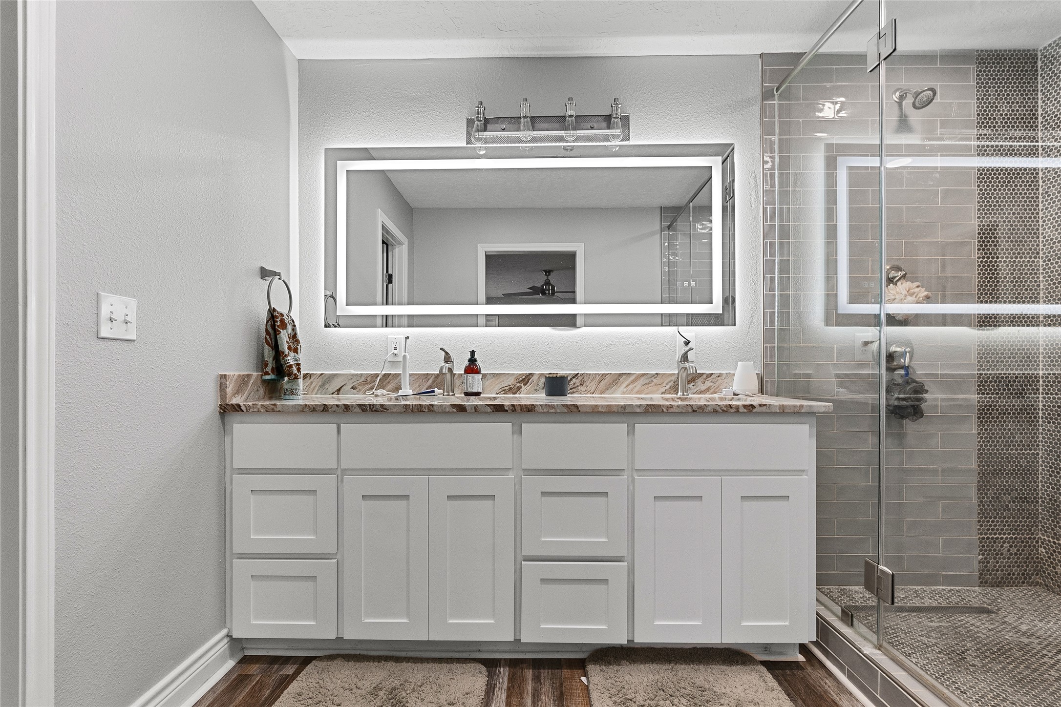 11050 Antioch Road Midway, TX 75852 - Photo 21 of 34 a bathroom with a granite countertop sink two mirror and a shower