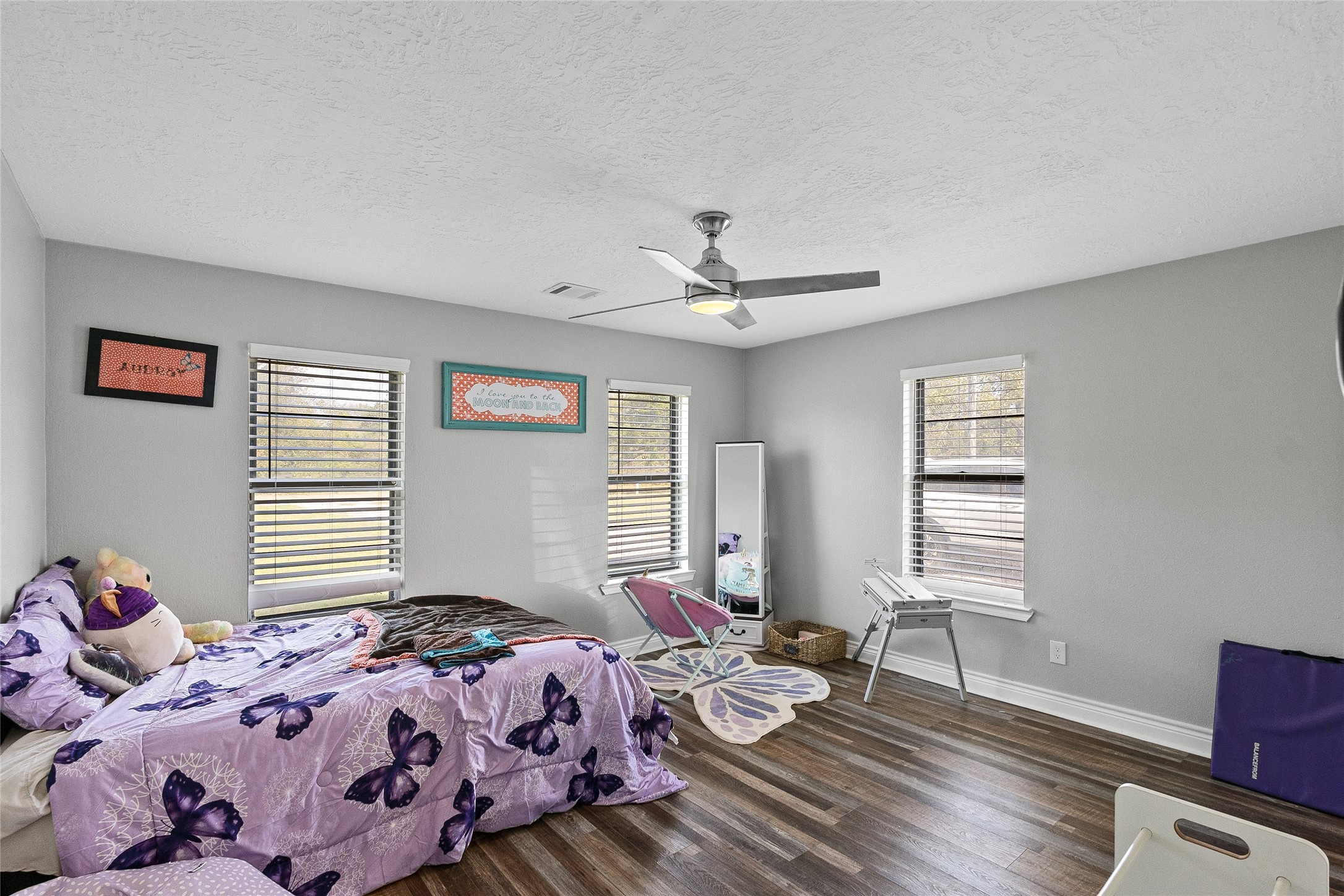 11050 Antioch Road Midway, TX 75852 - Photo 22 of 34 a bedroom with a bed and wooden floor