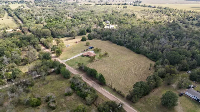 an aerial view of a residential houses with outdoor space