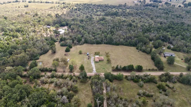 an aerial view of a house with a yard