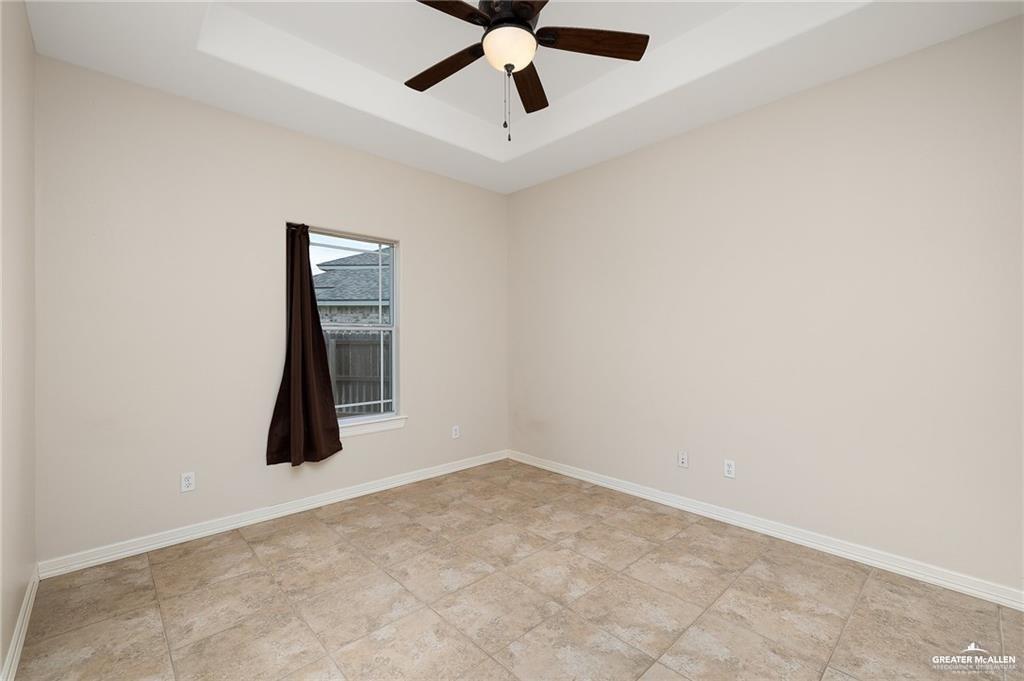 511 Mi Vida Street Weslaco, TX 78596 - Photo 12 of 13 an empty room with ceiling fan and window