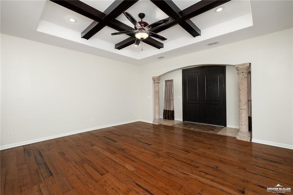 511 Mi Vida Street Weslaco, TX 78596 - Photo 3 of 13 an empty room with wooden floor and ceiling fan