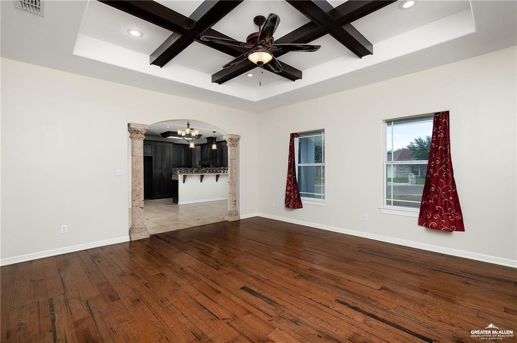 511 Mi Vida Street Weslaco, TX 78596 - Photo 4 of 13 a view of an empty room with wooden floor and a ceiling fan
