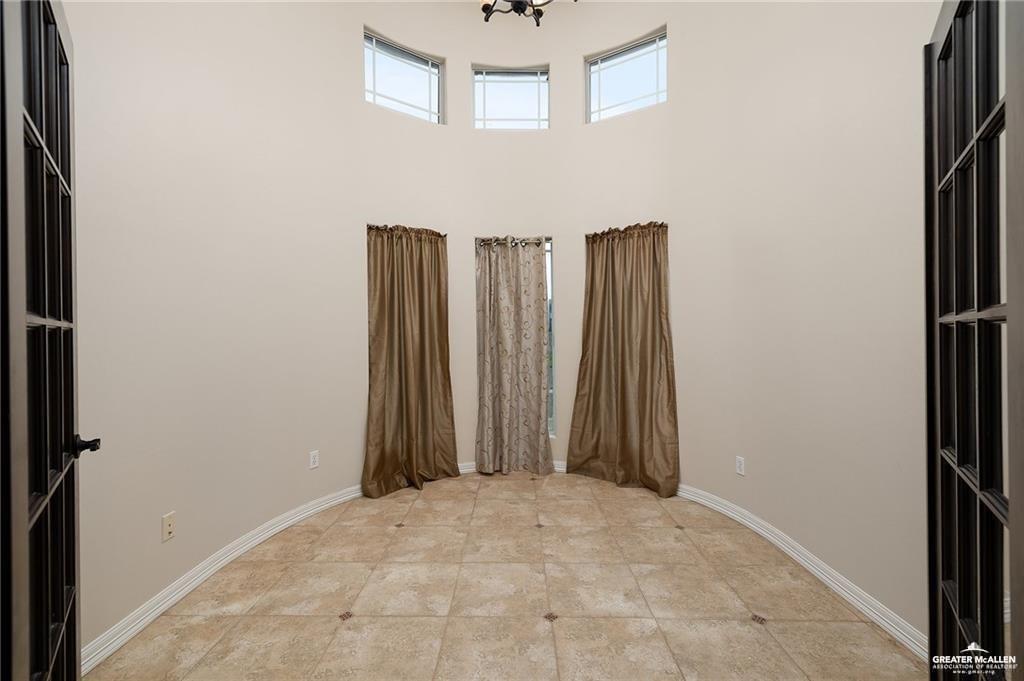 511 Mi Vida Street Weslaco, TX 78596 - Photo 7 of 13 a view of a hallway with wooden walls