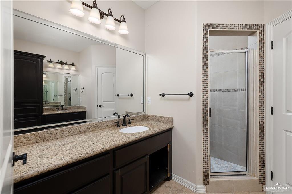 511 Mi Vida Street Weslaco, TX 78596 - Photo 9 of 13 a bathroom with double sink and a mirror