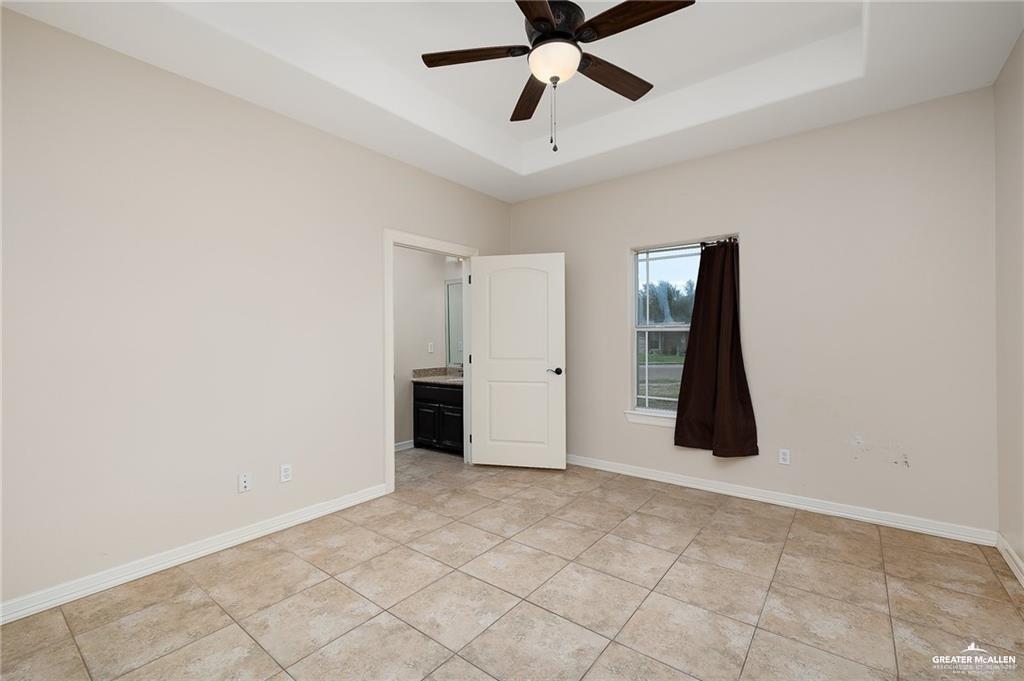 511 Mi Vida Street Weslaco, TX 78596 - Photo 10 of 13 a view of a livingroom with a ceiling fan and window