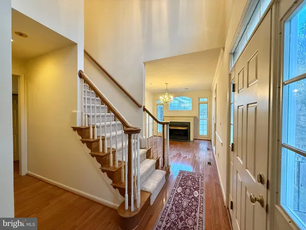 a view of entryway with wooden floor and a livingroom