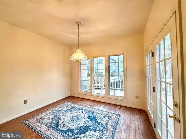a view of a livingroom with wooden floor fireplace and window