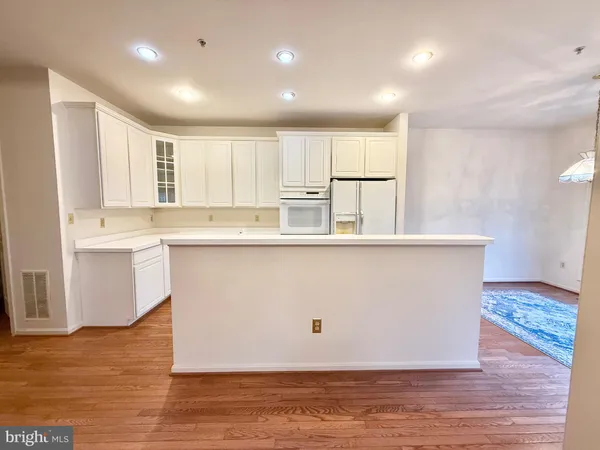 a kitchen with white cabinets and white appliances