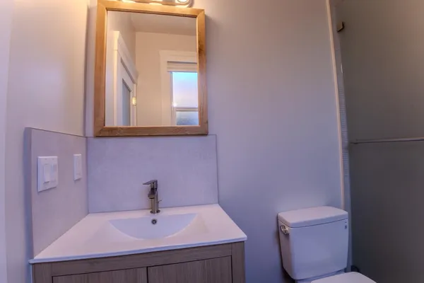 a bathroom with a sink mirror and shower