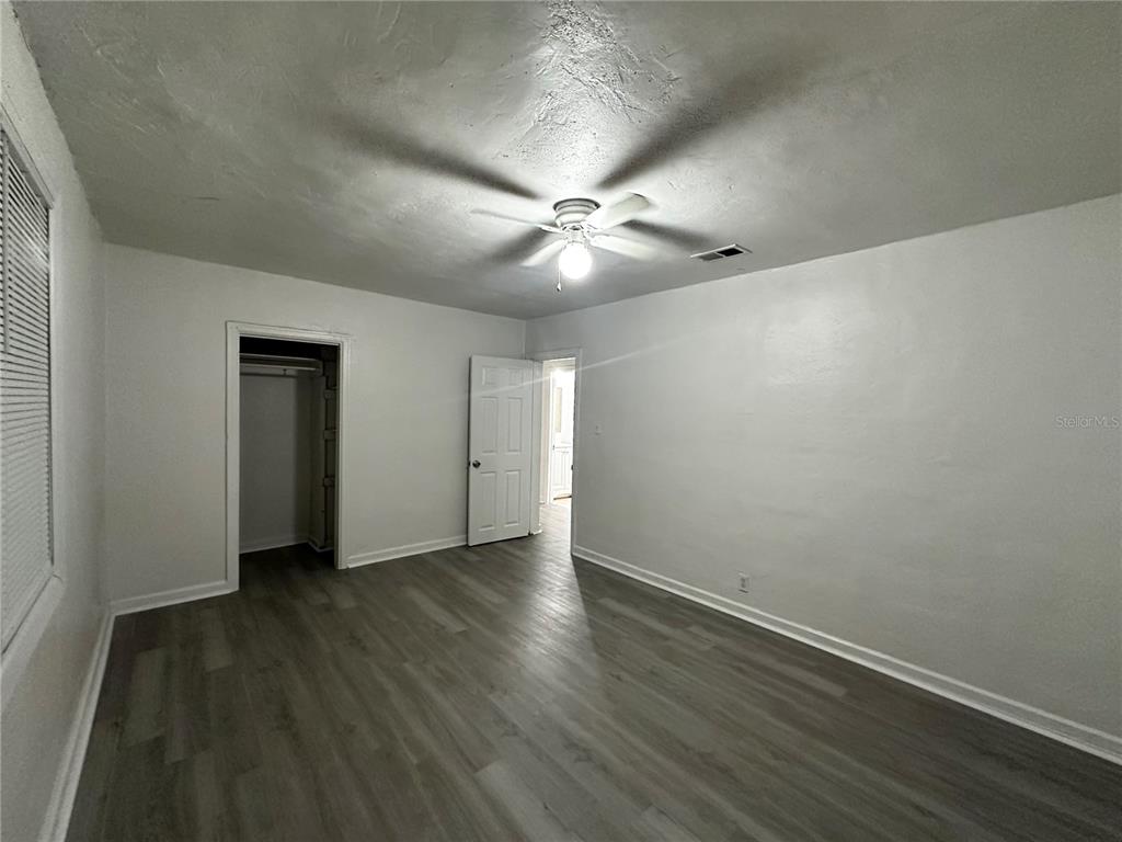 1907 Rio Grande Avenue Orlando, FL 32805 - Photo 14 of 17 an empty room with wooden floor ceiling fan and windows