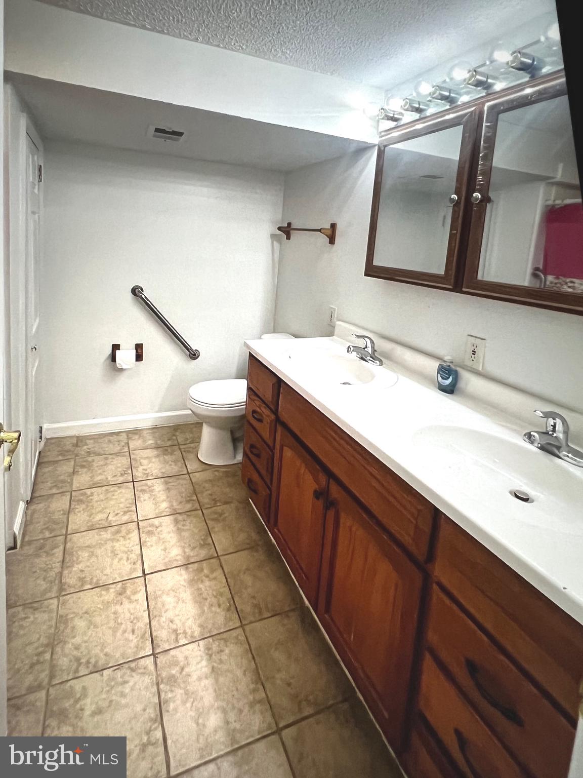 4457 Fenor Road Halethorpe, MD 21227 - Photo 14 of 29 a large bathroom with a sink a toilet and mirror