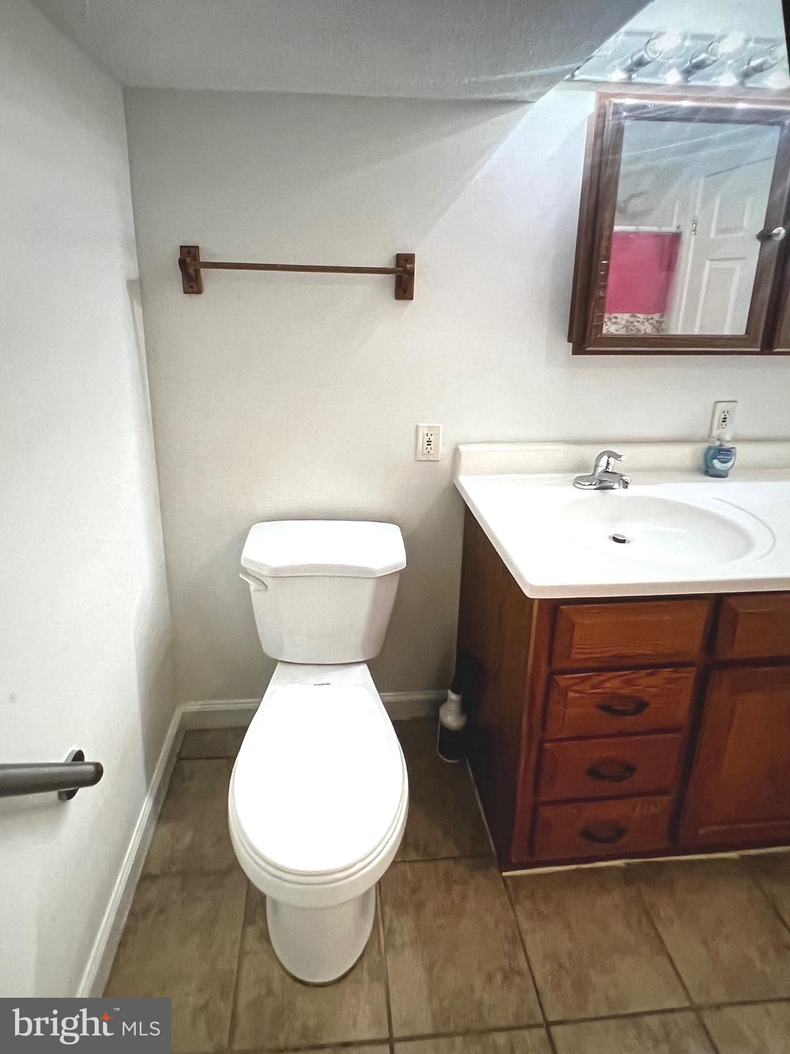 4457 Fenor Road Halethorpe, MD 21227 - Photo 15 of 29 a bathroom with a toilet sink and mirror