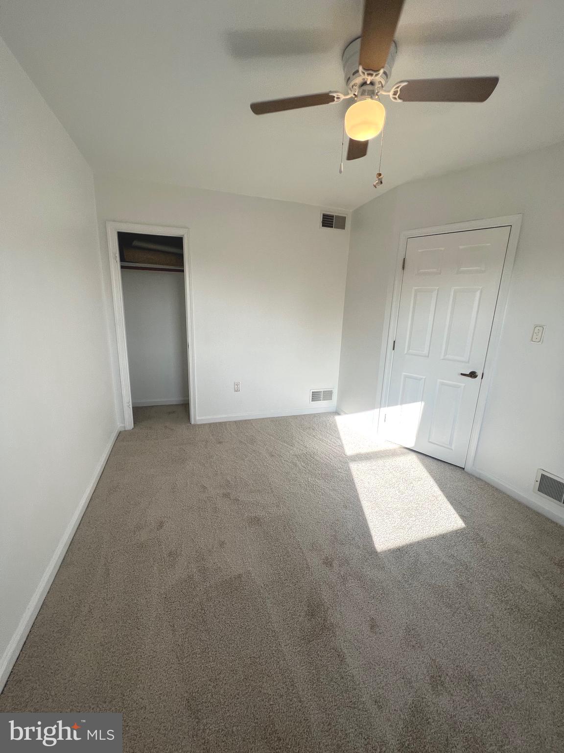 4457 Fenor Road Halethorpe, MD 21227 - Photo 28 of 29 an empty room with chandelier fan and windows