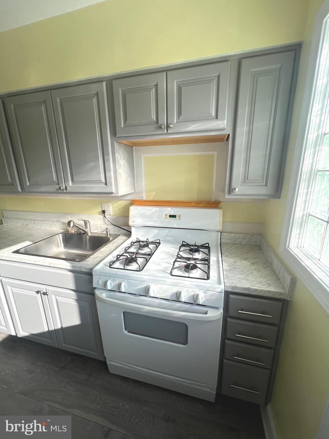 4457 Fenor Road Halethorpe, MD 21227 - Photo 3 of 29 a stove top oven sitting inside of a kitchen