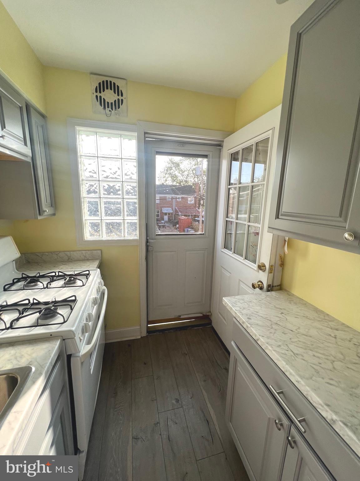 4457 Fenor Road Halethorpe, MD 21227 - Photo 6 of 29 a kitchen that has a sink a stove and a window