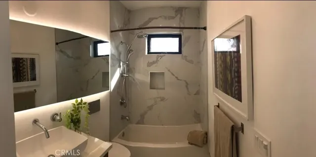 a bathroom with a tub and sink