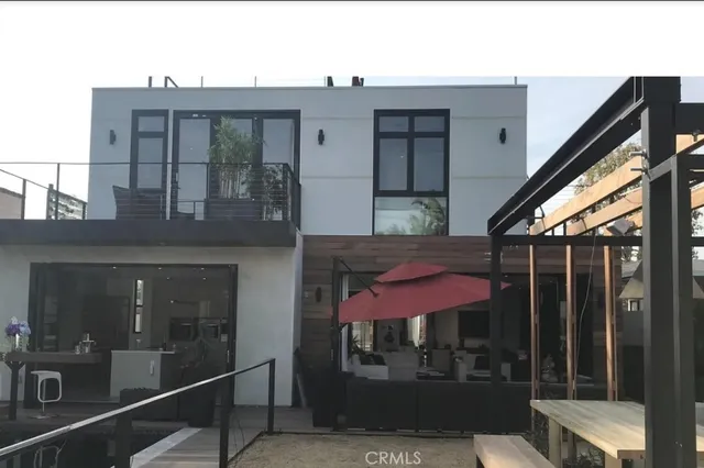a view of a brick building with a red door and a large window