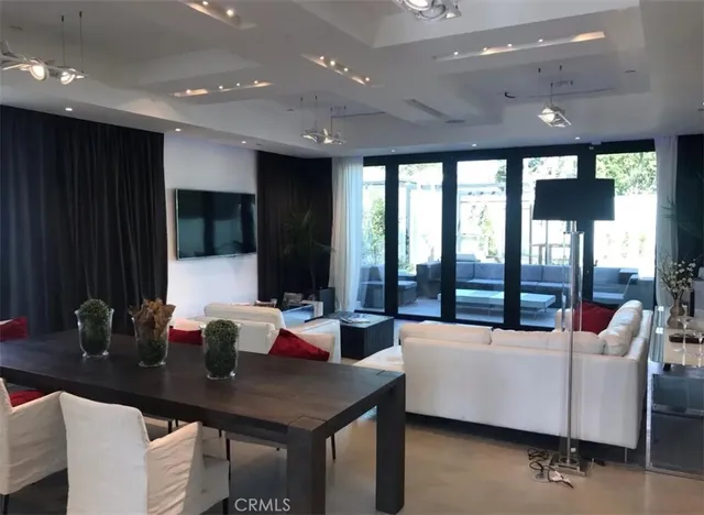 a living room with furniture a large window and a sink