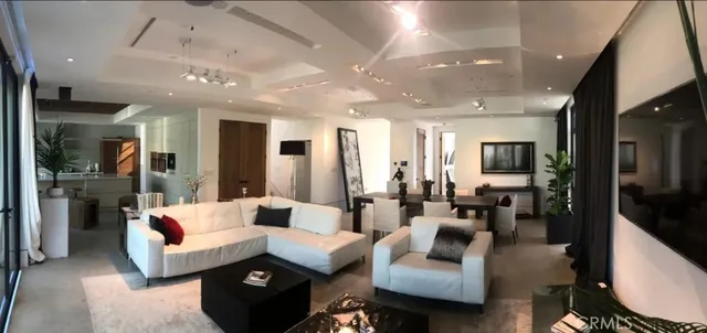 a living room with furniture and a large mirror