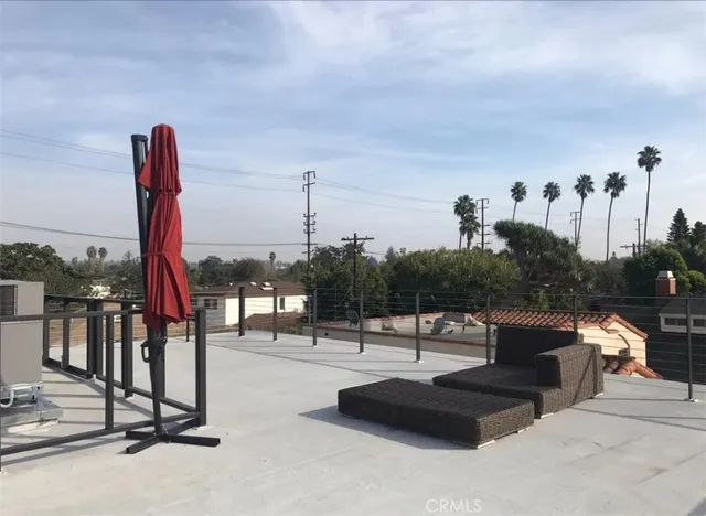 a roof deck with table and chairs