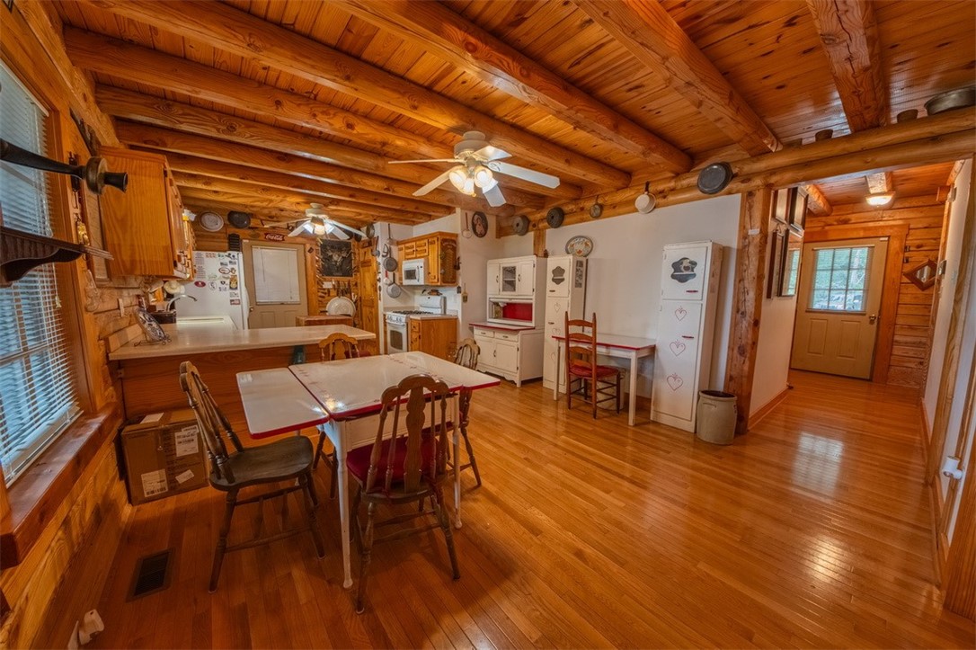 846 Twiggs Ferry Road Hartfield, VA 23071 - Photo 17 of 28 Dining area with light wood-style flooring, a wooden ceiling with exposed beams, and ceiling fan
