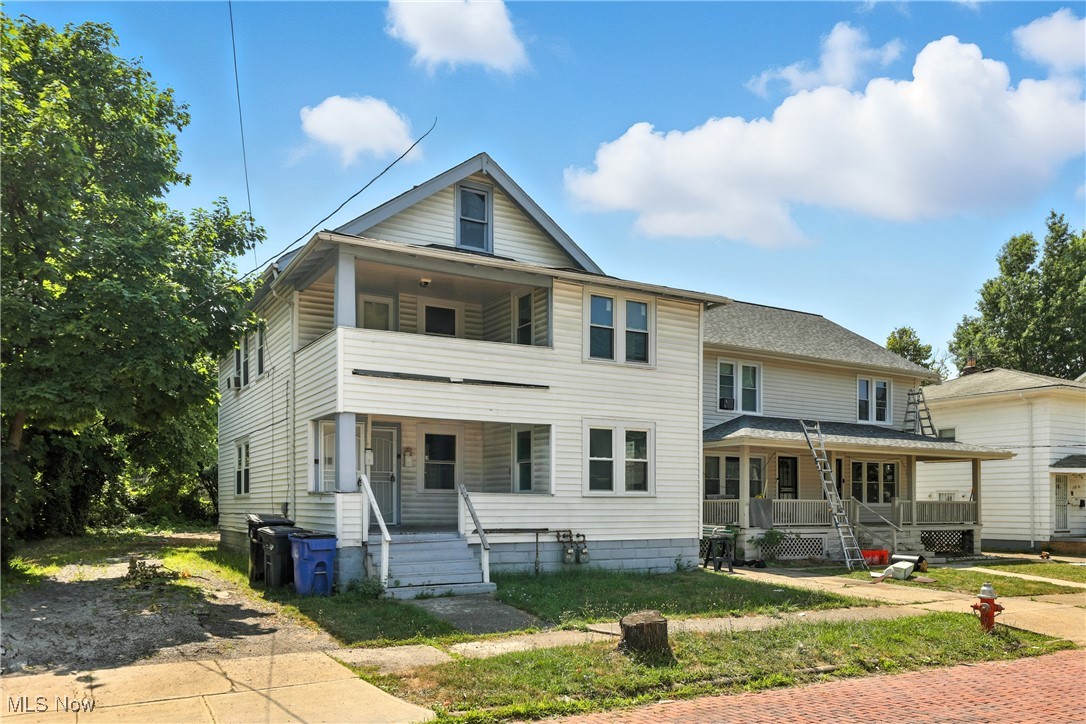 1774 Urbana Road Cleveland, OH 44112 - Photo 3 of 41 View of front of house with covered porch and a balcony