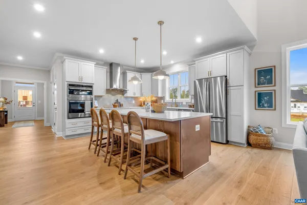 a living room with fireplace furniture and a large window