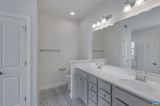 a bathroom with a sink a light fixture and a mirror