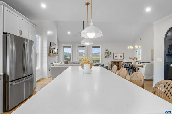 a living room with furniture and a view of kitchen